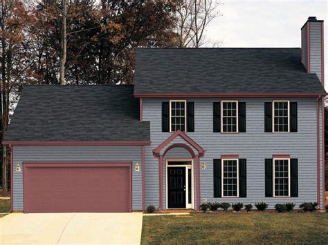 gray house with gray metal roof|grey house with black awnings.